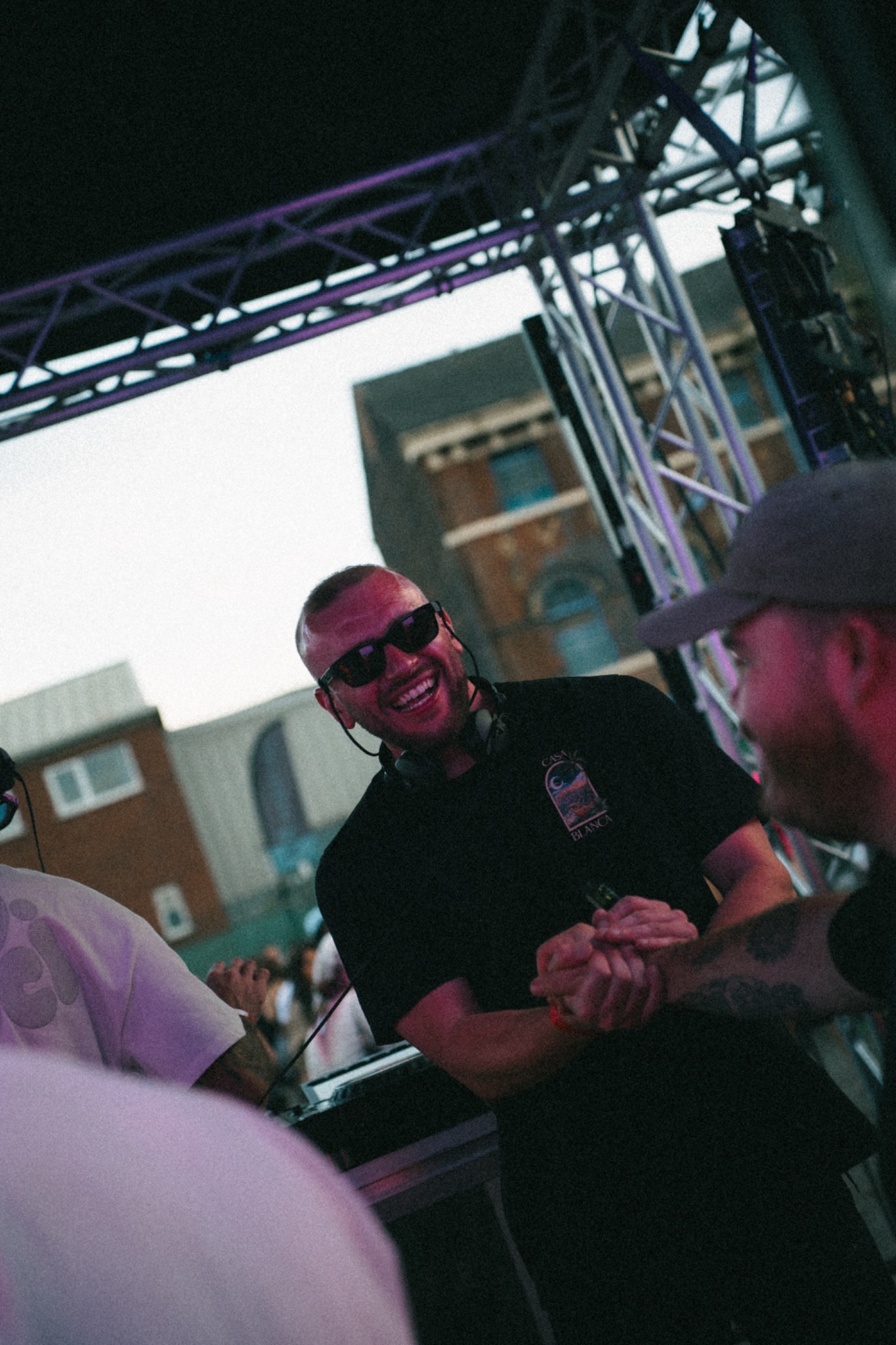 Brad smiling with headphones around his neck at a live event